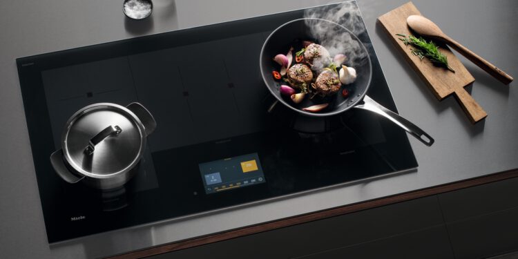 Das Miele-Induktionskochfeld KM 7999 bietet flexiblen Raum für bis zu fünf Kochgeschirre und wird über ein Touch-Display bedient. © Miele